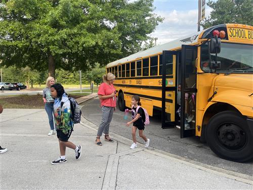bus unloading kids at school